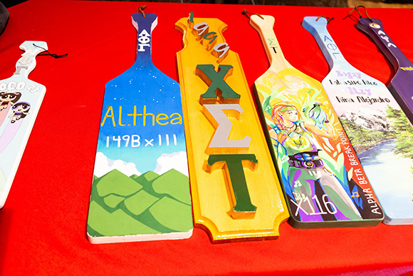 Fraternity and Sorority paddles set out on a table