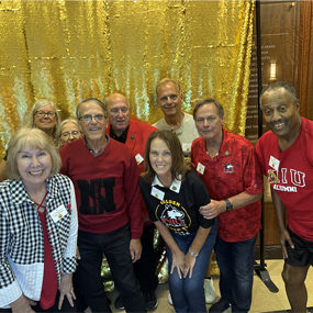 Small group of nine Golden Huskies at the reunion reception in 2025.