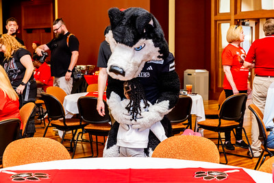 Victor E. Huskie giving a hug to a Young Child