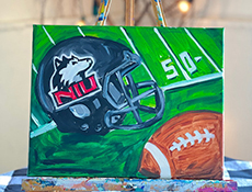 Painting option: NIU Football helmet and football on football field